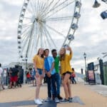 Teens taking a selfie in front of The Wheel.